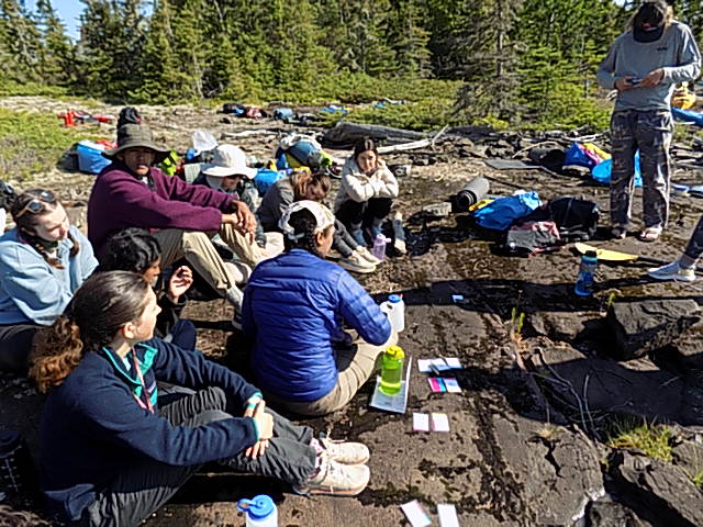 The group resting and planning on the rocks of Lake Superior