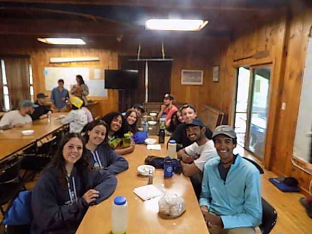 The group sharing their first real meal at a table after 22 days